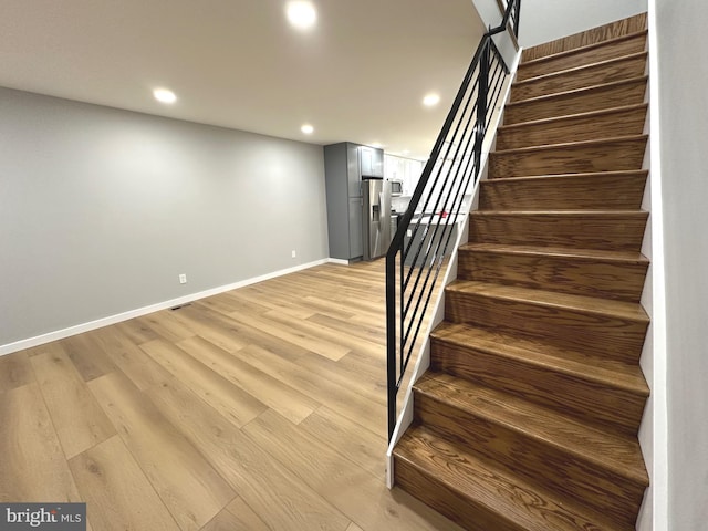 staircase featuring hardwood / wood-style flooring