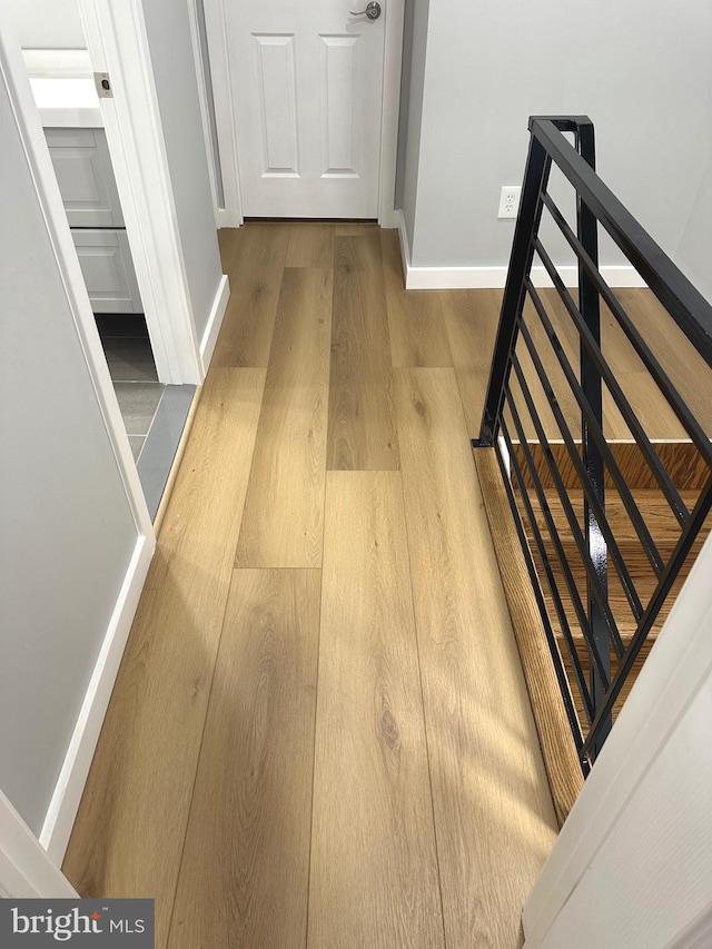 hallway with hardwood / wood-style floors