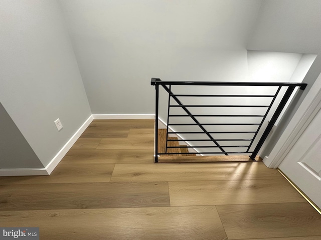 staircase with wood-type flooring