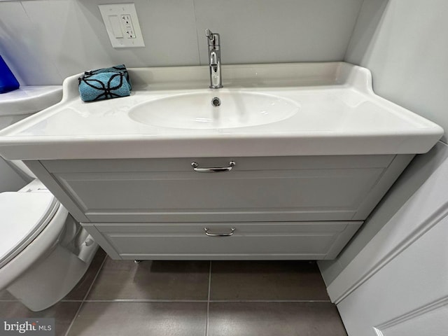 bathroom with tile patterned flooring, toilet, and sink