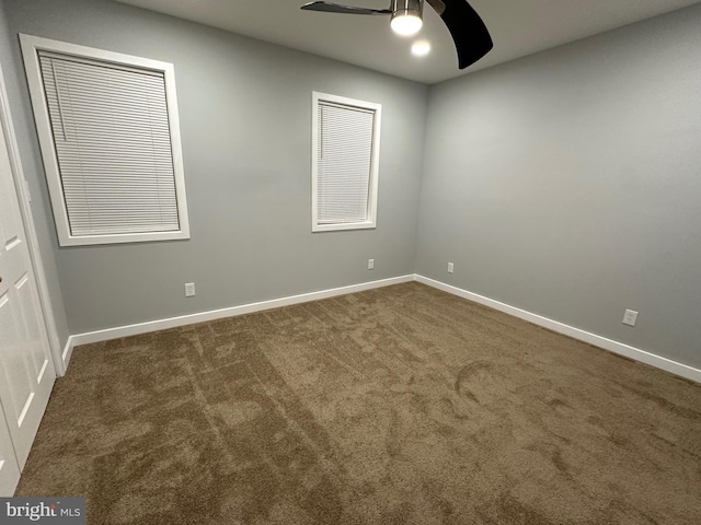 carpeted empty room featuring ceiling fan