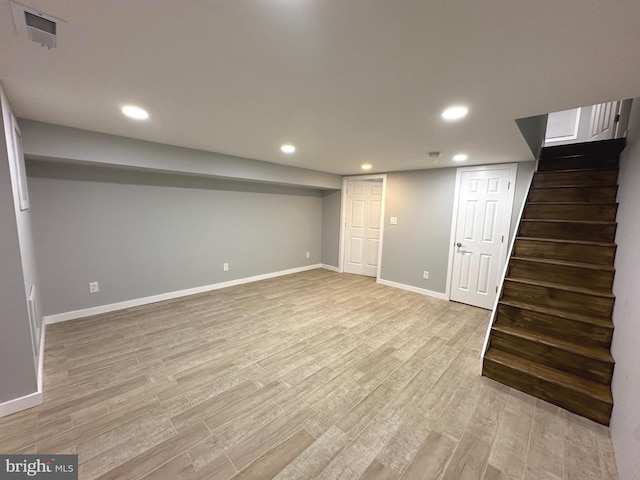 basement with light hardwood / wood-style floors