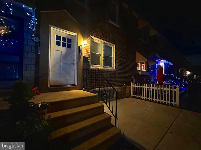 view of exterior entry at night