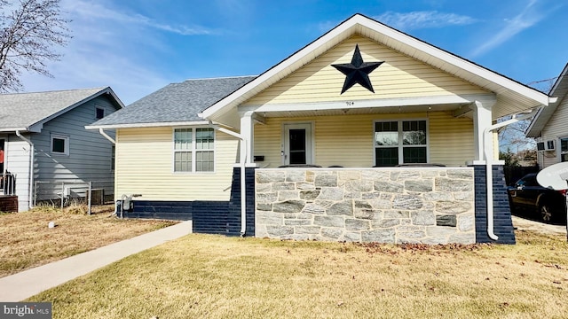 bungalow with a front lawn and a porch