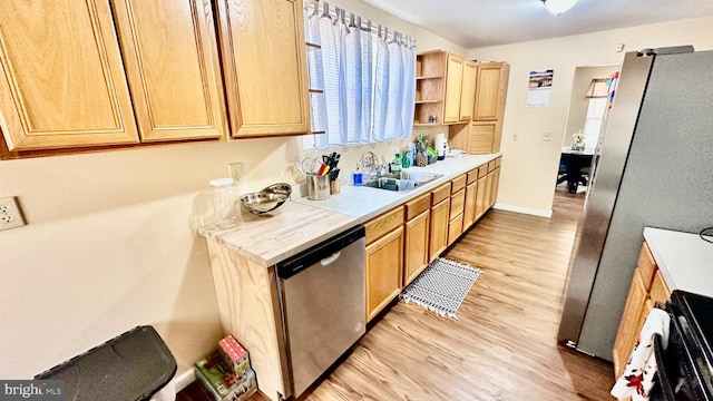 kitchen featuring light brown cabinetry, sink, stainless steel appliances, and light wood-type flooring