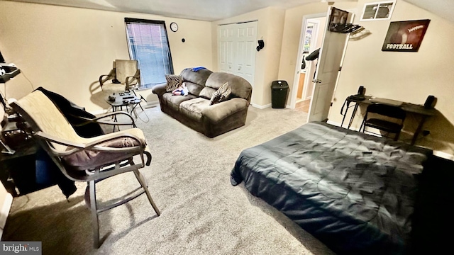 carpeted bedroom featuring vaulted ceiling and a closet