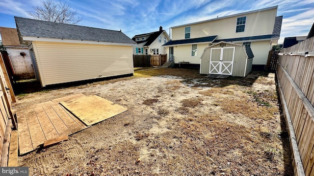 back of property with a storage shed