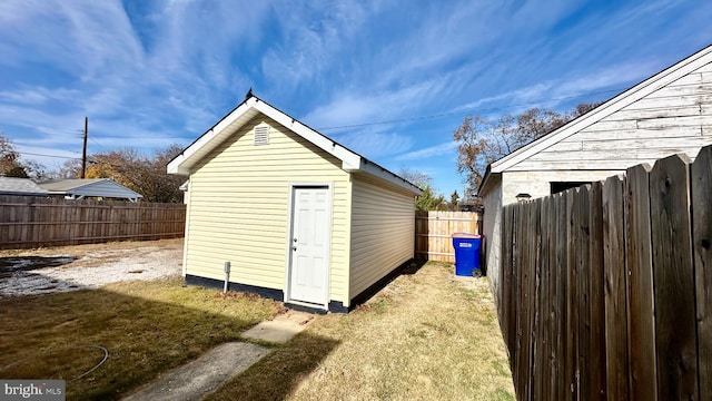 view of outbuilding featuring a lawn