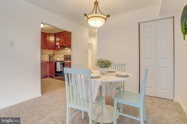 dining space featuring light tile patterned floors