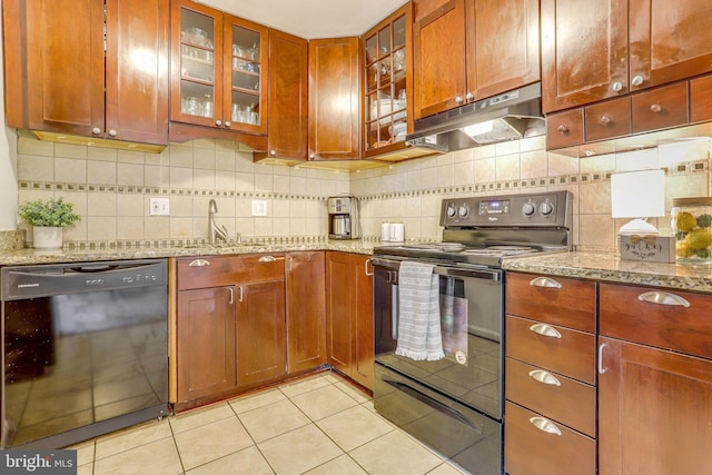 kitchen with decorative backsplash, light stone counters, sink, black appliances, and light tile patterned flooring