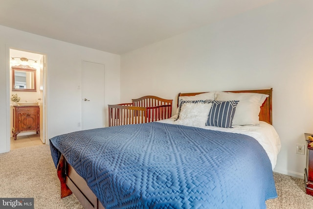 carpeted bedroom featuring connected bathroom