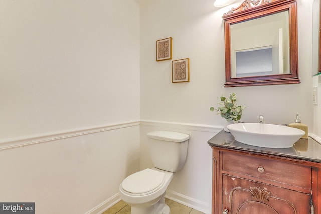 bathroom featuring tile patterned flooring, vanity, and toilet