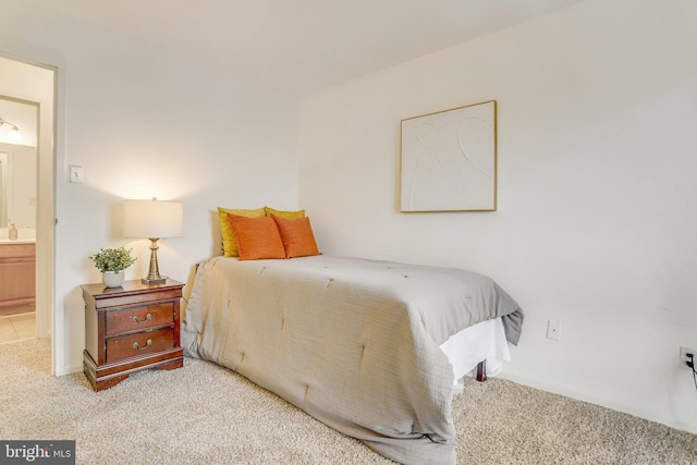 carpeted bedroom featuring connected bathroom