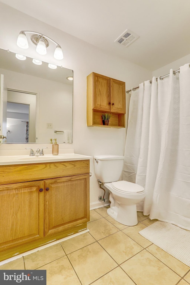 bathroom with tile patterned flooring, vanity, toilet, and a shower with curtain