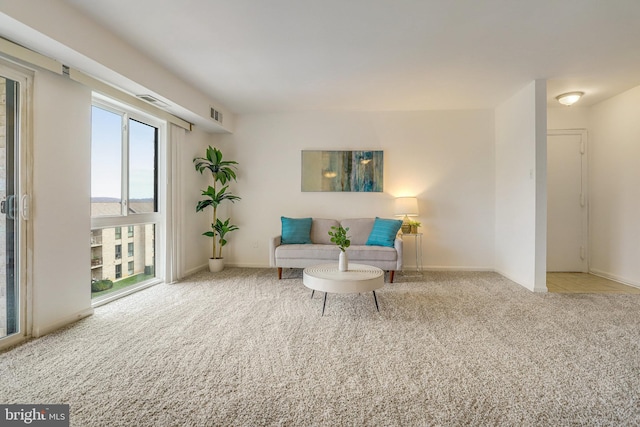 sitting room featuring light colored carpet