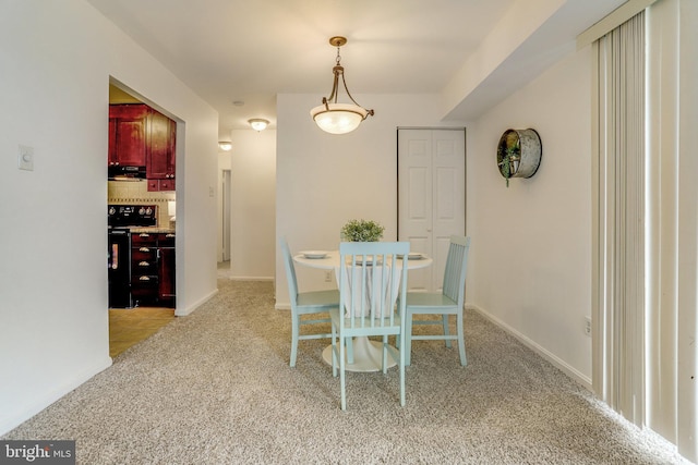 dining room with light colored carpet