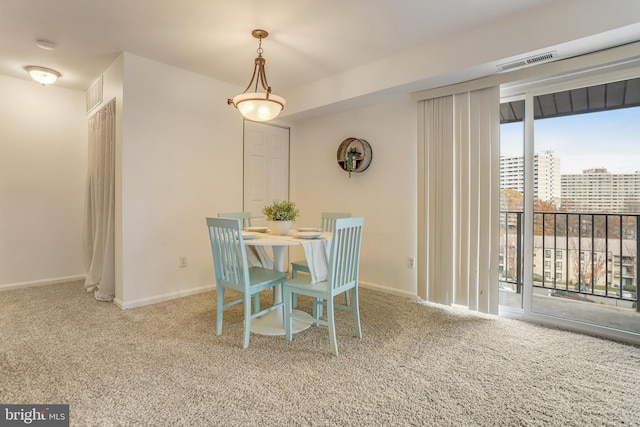 dining space with carpet flooring