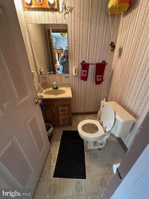 bathroom featuring vanity and toilet