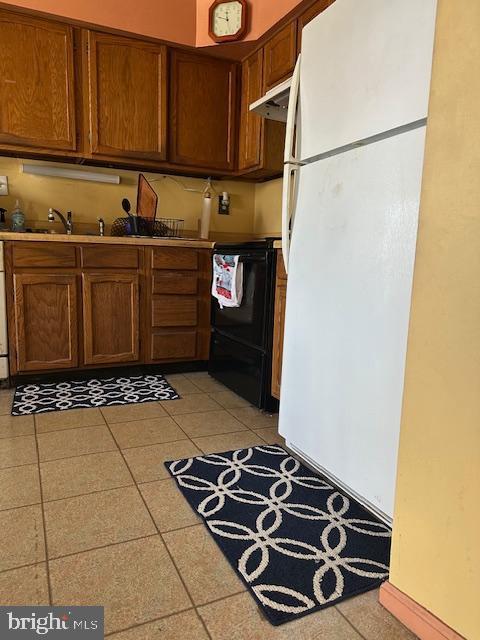 kitchen featuring range and white fridge