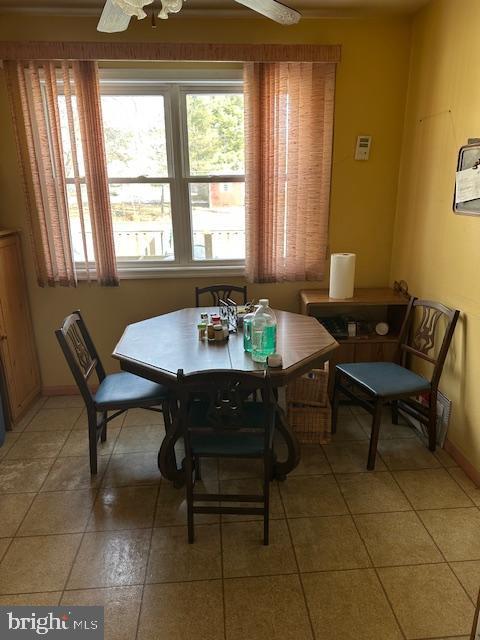 dining space featuring tile patterned floors and ceiling fan