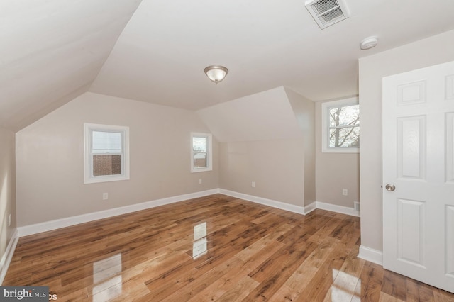 bonus room featuring wood-type flooring and lofted ceiling