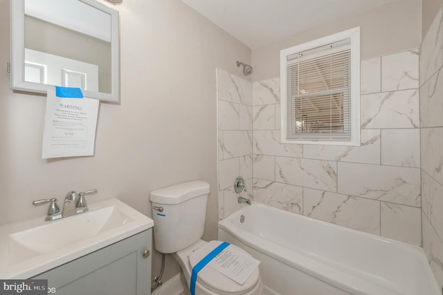 full bathroom with vanity, tiled shower / bath combo, and toilet