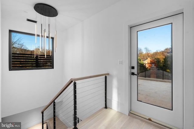 doorway to outside with light wood-type flooring