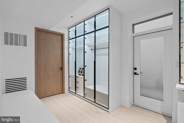 doorway with light hardwood / wood-style floors