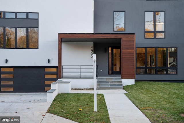 view of front of house with a garage and a front lawn