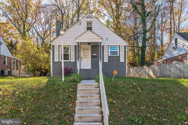 bungalow-style home featuring central AC and a front lawn