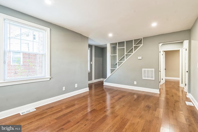 unfurnished room with hardwood / wood-style floors