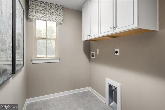 laundry area with cabinets, hookup for a washing machine, and electric dryer hookup