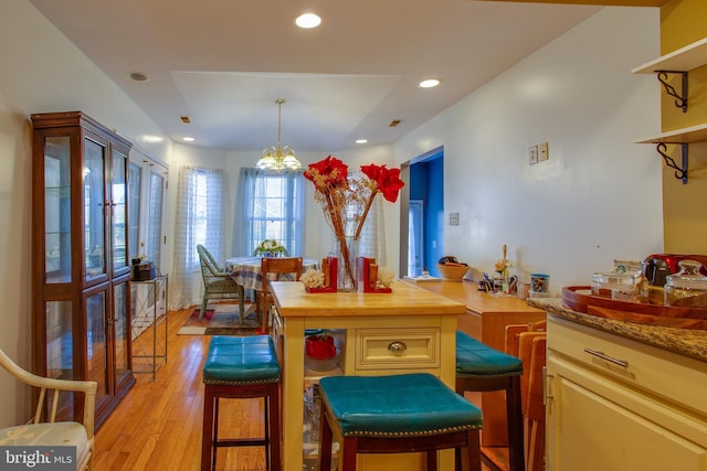 dining room featuring light hardwood / wood-style flooring and a notable chandelier