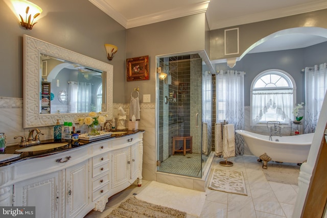 bathroom with vanity, crown molding, tile walls, and independent shower and bath