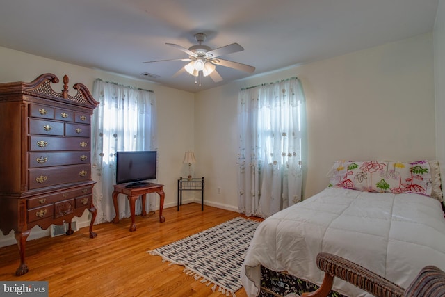 bedroom with ceiling fan and light hardwood / wood-style floors