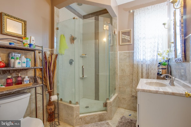 bathroom with toilet, plenty of natural light, vanity, and walk in shower