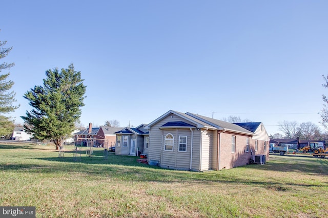 view of side of home featuring a yard and cooling unit