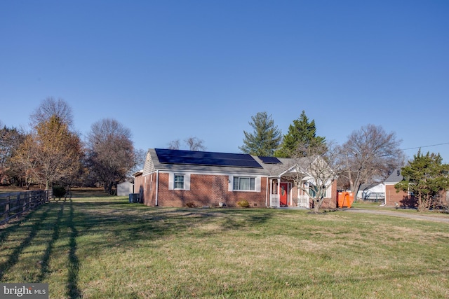 single story home with solar panels and a front lawn