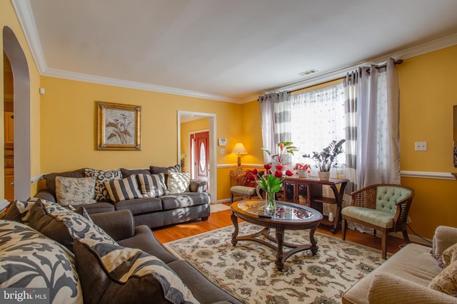 living room featuring wood-type flooring and ornamental molding