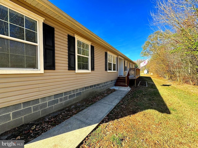 view of side of home with a lawn