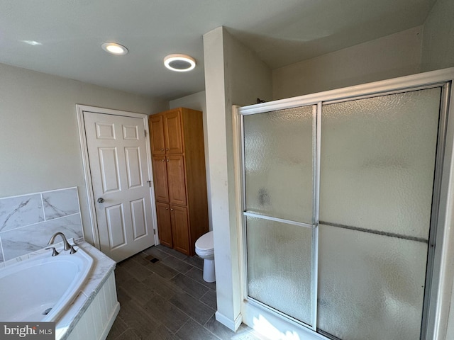 bathroom with toilet, wood-type flooring, and separate shower and tub