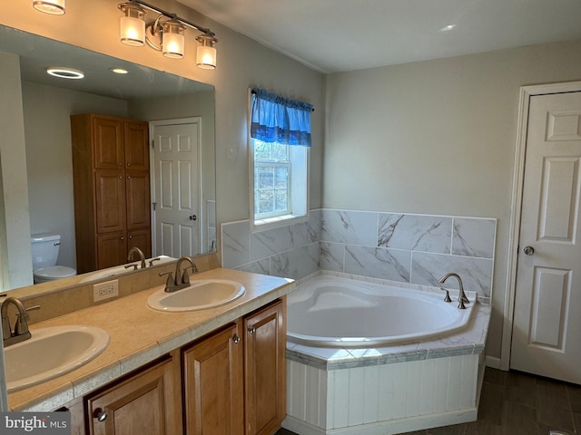 bathroom featuring wood-type flooring, vanity, a relaxing tiled tub, and toilet