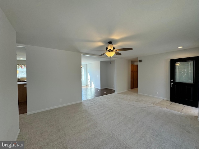 interior space featuring ceiling fan and light colored carpet