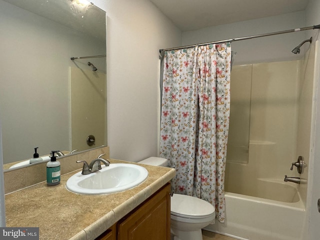 full bathroom with vanity, shower / bath combo, and toilet