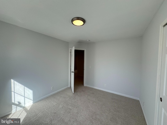 empty room featuring light carpet