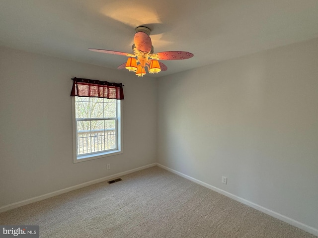 unfurnished room with carpet and ceiling fan