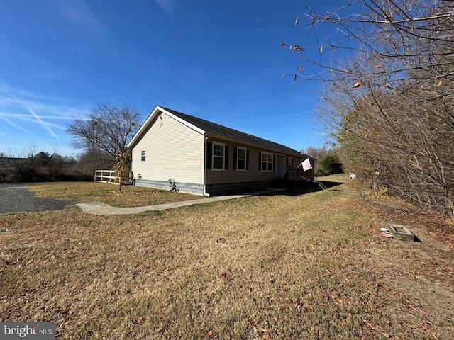 view of side of home featuring a yard