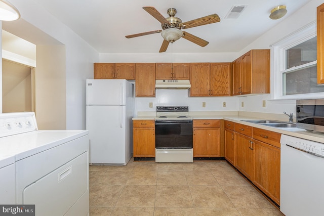 kitchen with visible vents, a sink, washer / dryer, white appliances, and under cabinet range hood