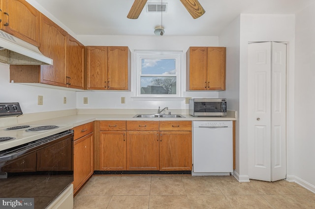 kitchen featuring under cabinet range hood, a sink, electric stove, dishwasher, and stainless steel microwave