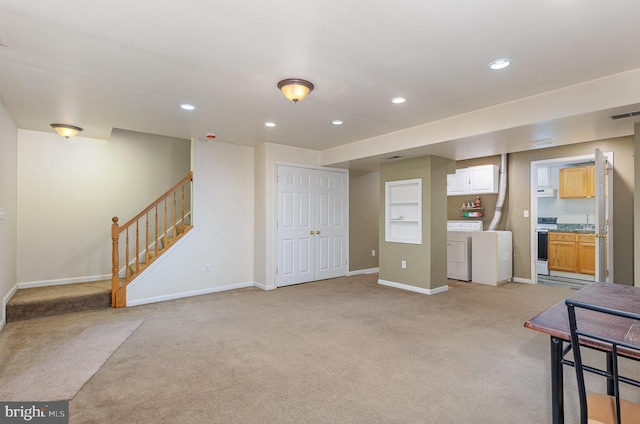 interior space with light carpet, baseboards, independent washer and dryer, stairs, and recessed lighting